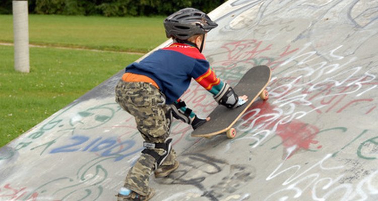 Young skateboarder making his way up the ramp