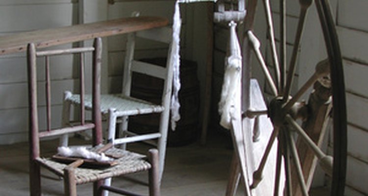 Traditional spinning wheel chairs feature a tall, skinny back and angled legs similar to a Windsor style chair.