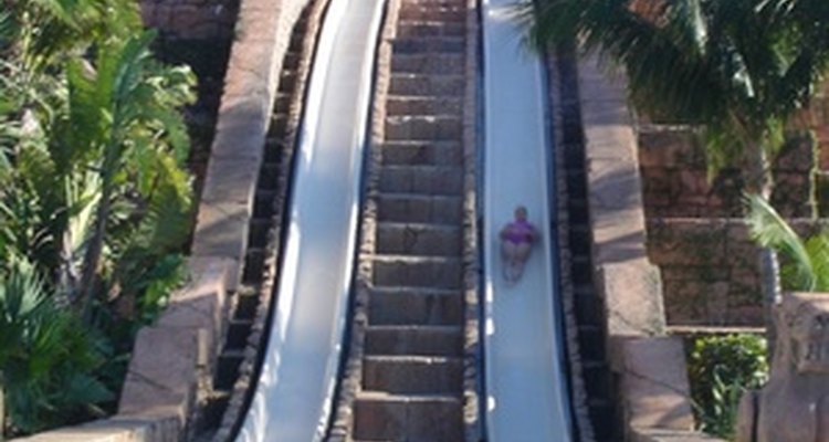 Water slides send riders into a pool.
