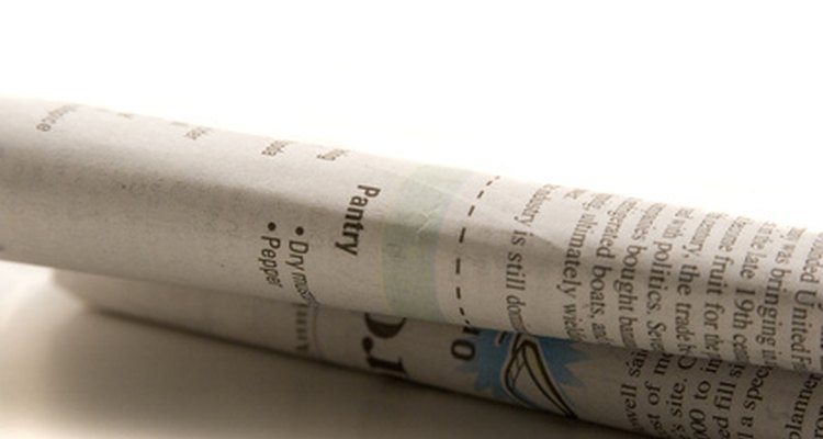Tear thick strips of newspaper to cover more areas on your mask.