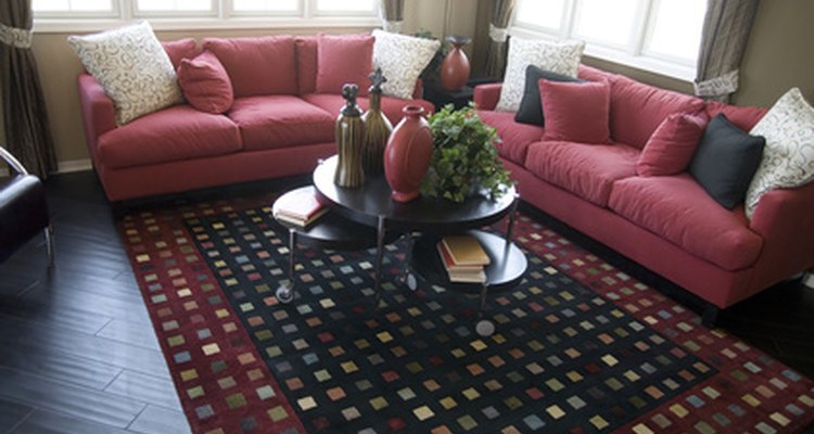 This room's cranberry-coloured furnishings balance well with its dark wood floor.