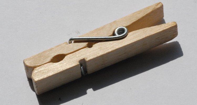 Any spring-loaded clothespin will keep the pennies separated until you squeeze them together.