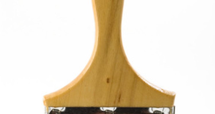 Use a broad-bristled brush to apply size to a wall.