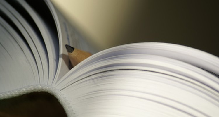 Straighten your curled paperback book by using two hardcover books to support it.