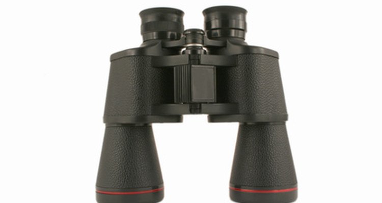 Clean interior lenses of binoculars by disassembling them.