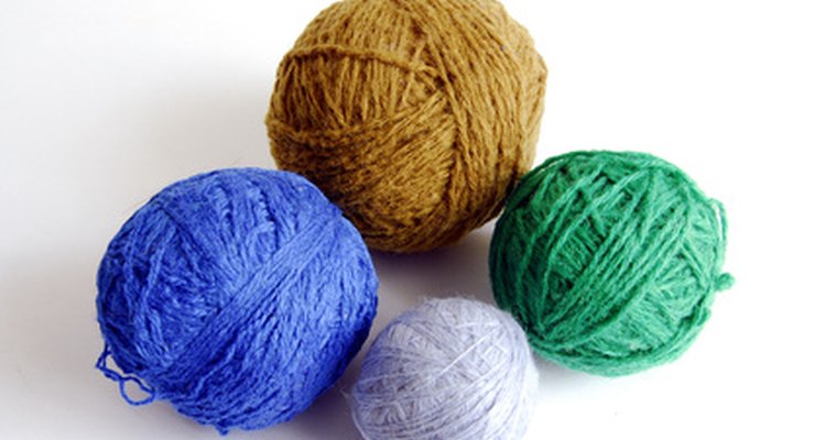 Turn yarn into hand knit flat-top hats.