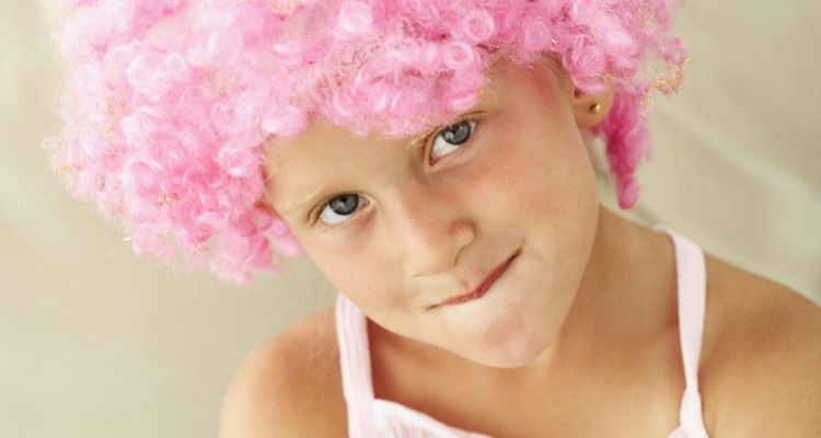 Close-up of a girl wearing a curly pink wig