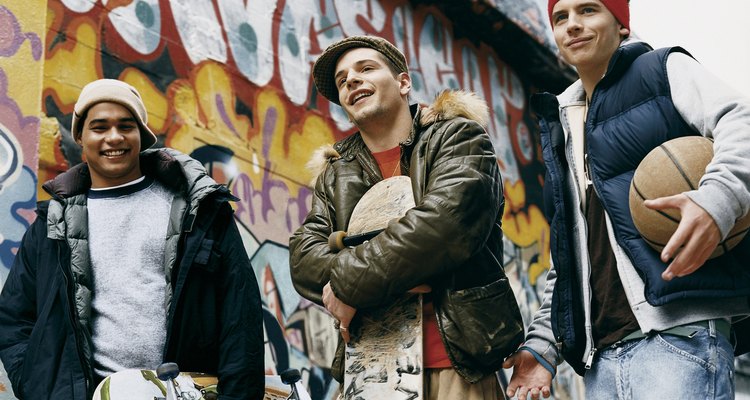 Teenage Boys Standing in an Urban Backstreet Holding Skateboards and a Basketball