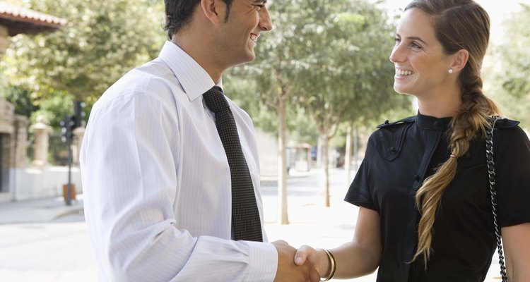 Businesspeople shaking hands outdoors