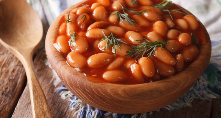 white beans in tomato sauce in a wooden bowl