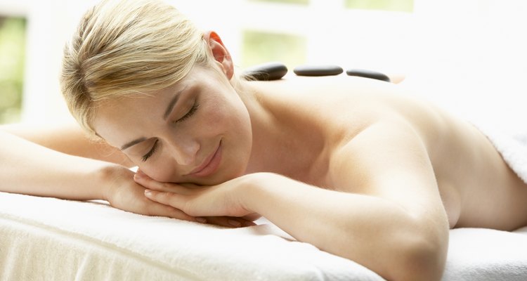 Young Woman Enjoying Hot Stone Treatment