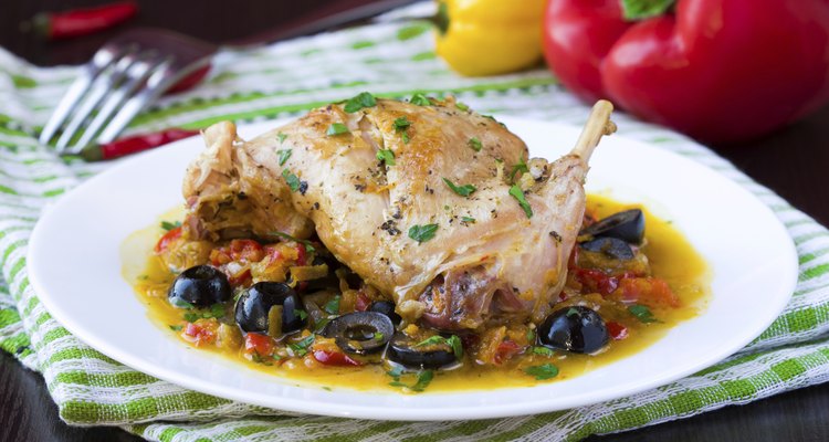 Ragout from stewed legs of rabbit with herbs, vegetables, olive