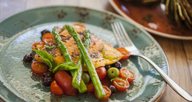 organic Arctic char fish on a bed of roasted tomatoes