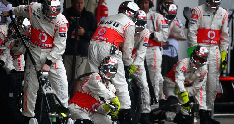 Mechanics work in the pit crews during races.