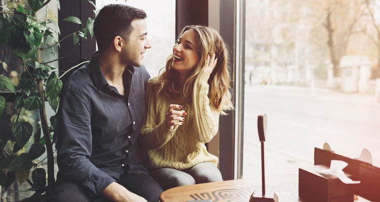 Couple in love drinking coffee and have fun in coffee shop. Love concepts. Vintage effect style picture