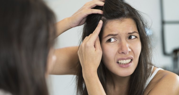 Horrified young woman looking in the mirror