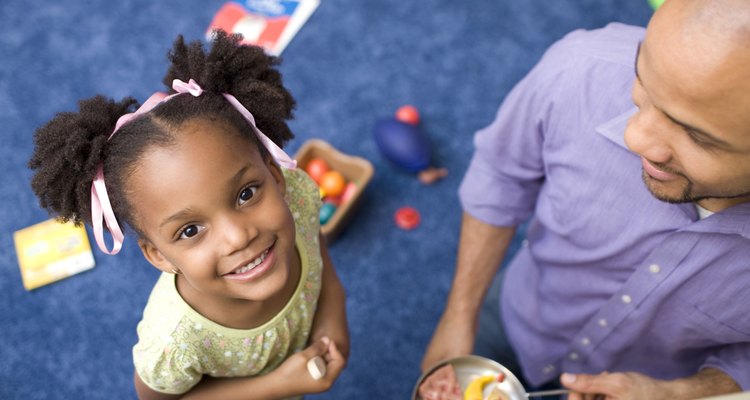 Portrait of girl with father in playroom