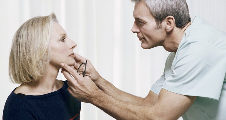 Cosmetic Surgeon Examining a Patients Face