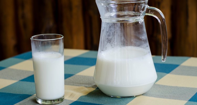 Pitcher and glass of milk checkered tablecloth in a farm