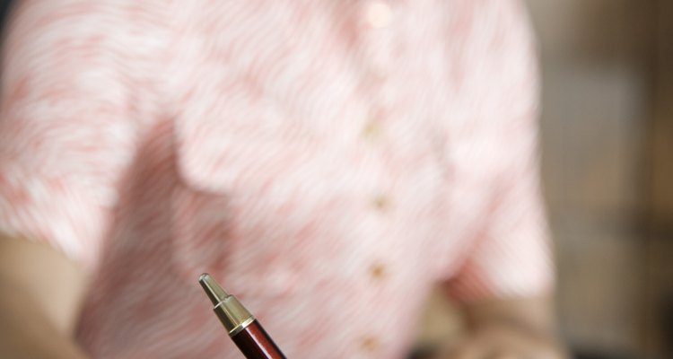 Businesswoman writing at desk