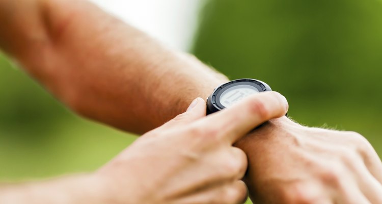 Trail runner looking at sport watch