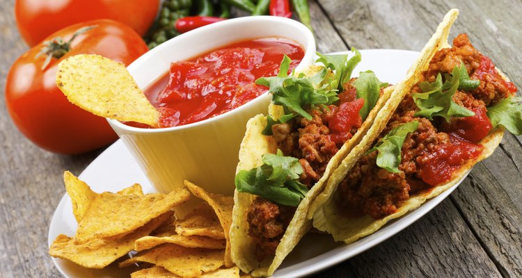 plate with taco, nachos chips, tomato dip