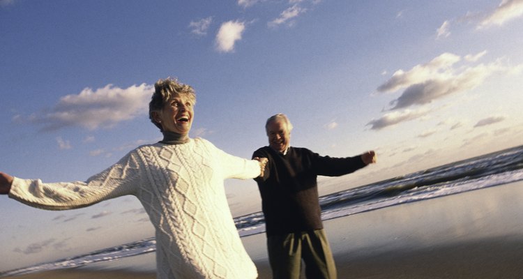 Senior couple holding hands on beach