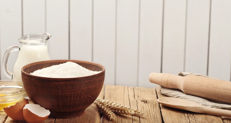 Flour in a bowl on a rustic wooden kitchen table