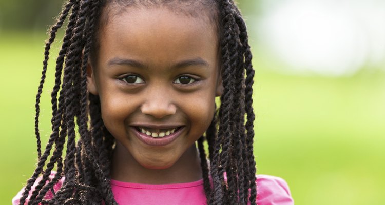 Outdoor close up portrait of a cute young black girl