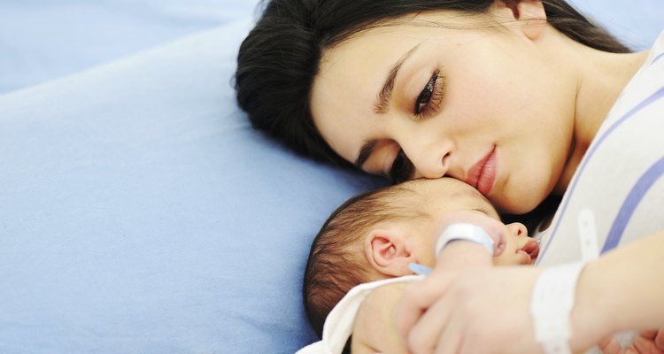 Woman holding her newborn baby at hospital