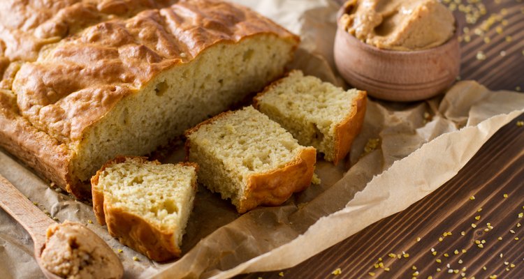 Corn bread cut in squares on baking paper, peanut butter