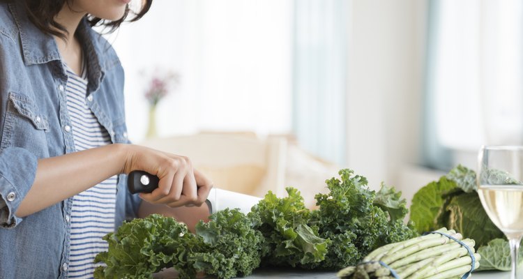 Hispanic woman chopping salad greens