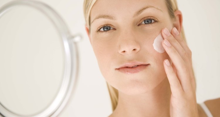 Woman applying moisturizer