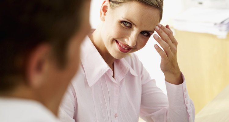 businesswoman smiling at a businessman