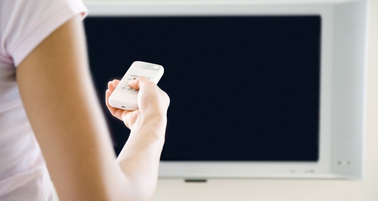 Hand holding tv remote control