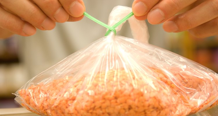 Hands tying bag of cereal in health food store