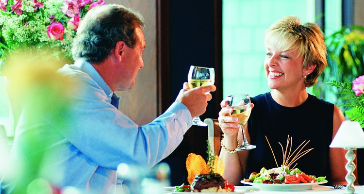 Photo, middle-aged couple making a toast over dinner, High res, Color