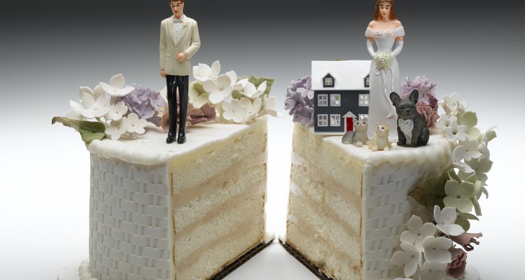 Bride and groom figurines standing on two separated slices of wedding cake