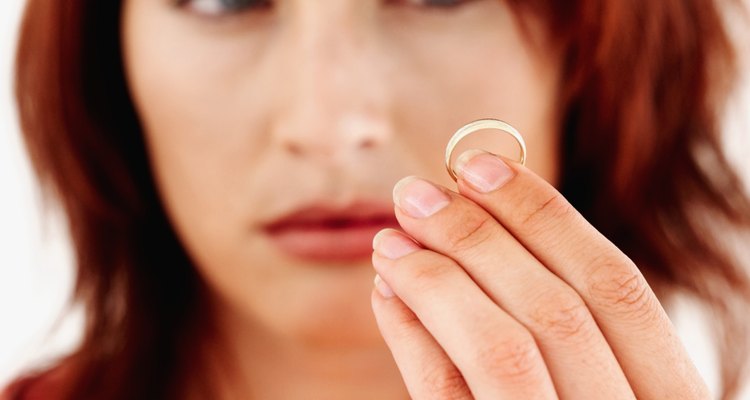 Young woman looking at a ring in her hand