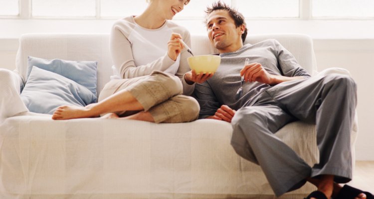 low angle view of a couple sitting on a couch and eating