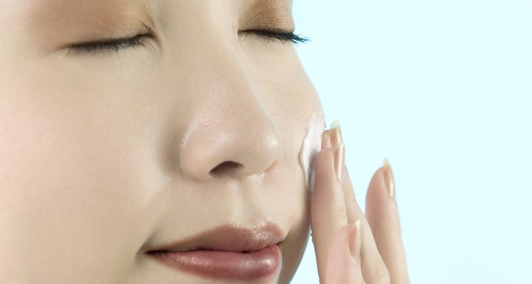 Young Woman Applying Moisturizer