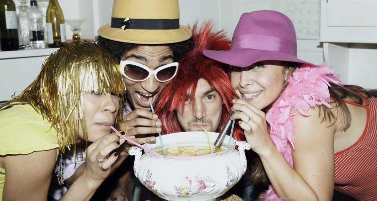 Friends in costume drinking punch through straws