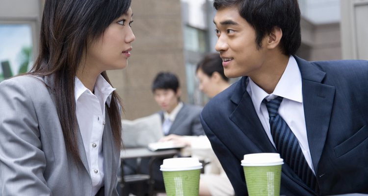 Businessman And Businesswoman Resting at Outdoor Table, Differential Focus, China, Beijing