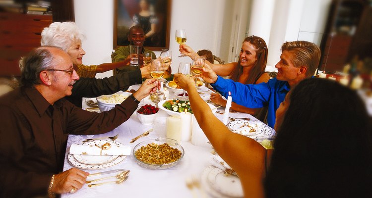 portrait of a family toasting at the dinner table
