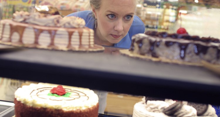 Mid adult woman looking at cakes in a supermarket