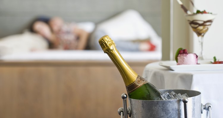 Person by bottle of champagne in bucket
