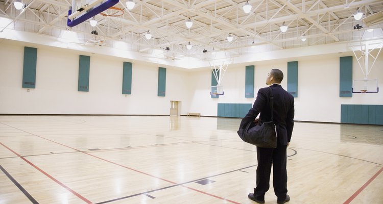 Asian businessman on empty basketball court