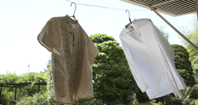 Shirts on coat hangers on washing line