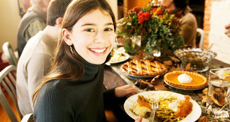 Smiling girl at Thanksgiving dinner with family