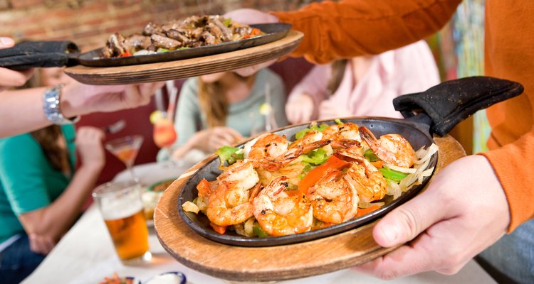 Person serving hot food at restaurant